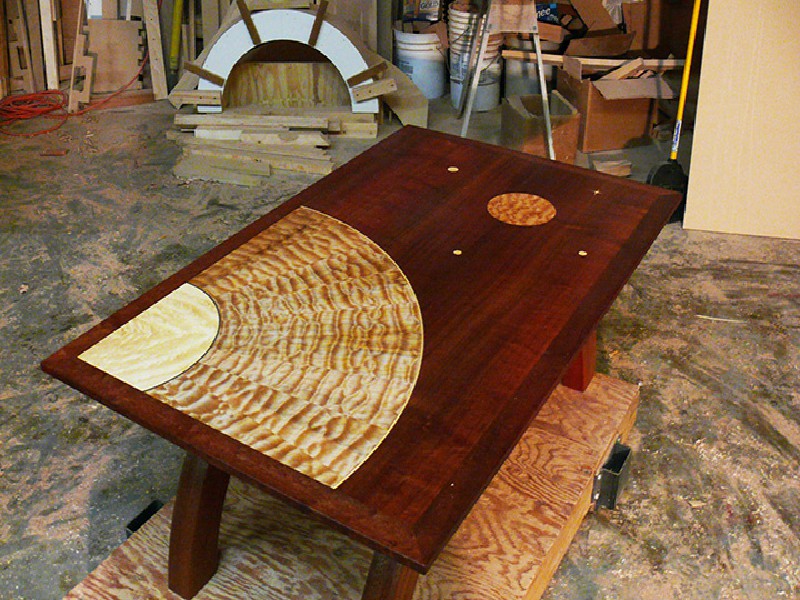 Think Big, The base is African mahogany, the center of the sun is eastern maple, the rays and the moon are quilted western maple, the rest of the top is African mahogany. The top is 48 inches X 32 inches / 18 inches high.